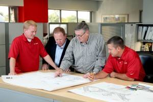 David Hood, Director of Business Development, looks over prints with the EPS Engineering team