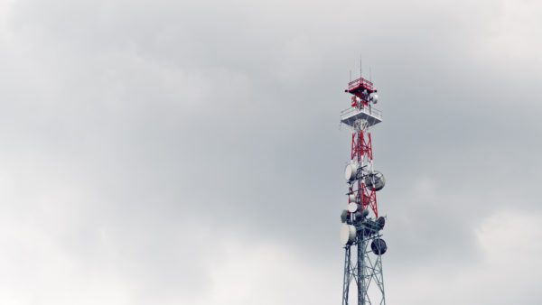 Cell tower against gray sky