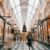 woman walking through a mall decorated for christmas