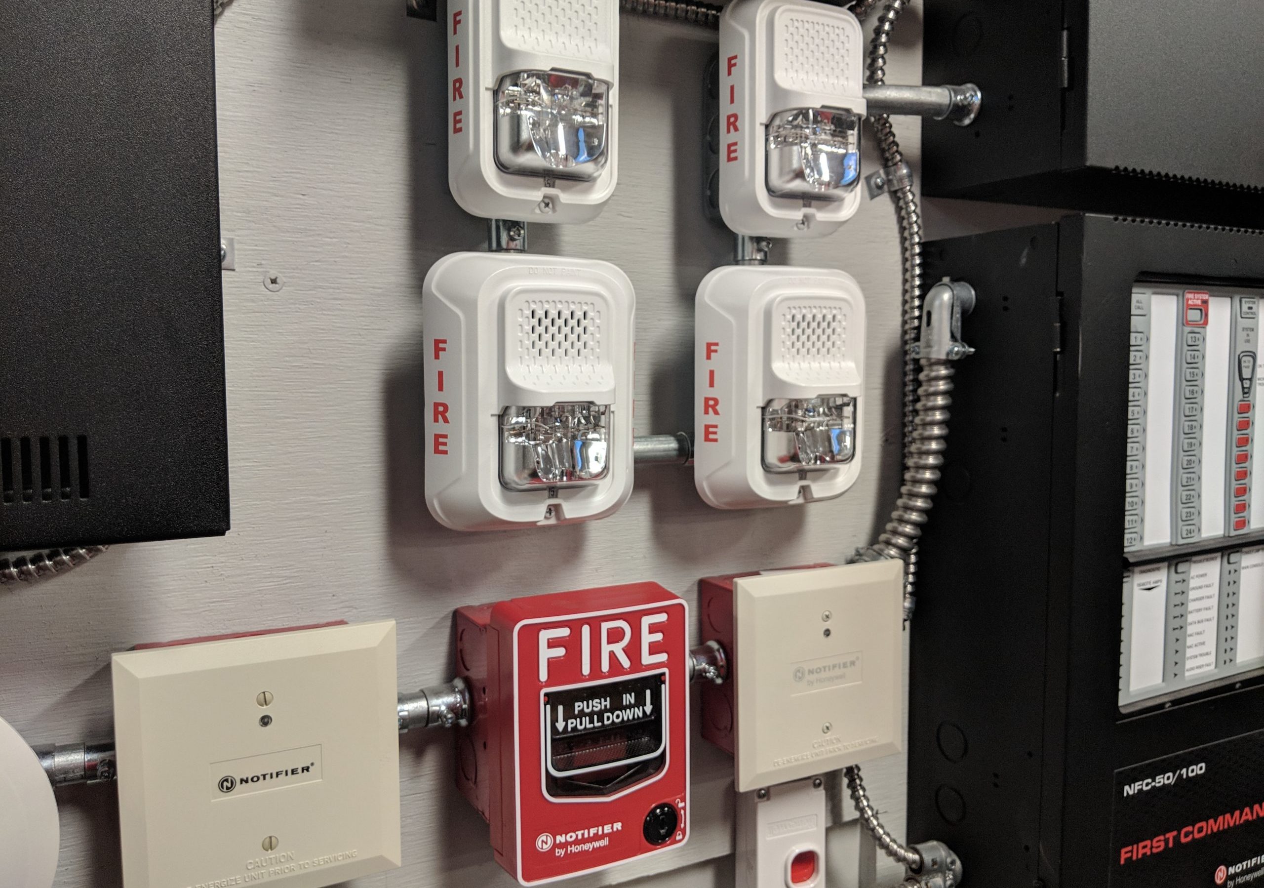 Fire alarm devices and equipment against a wall in a training environment